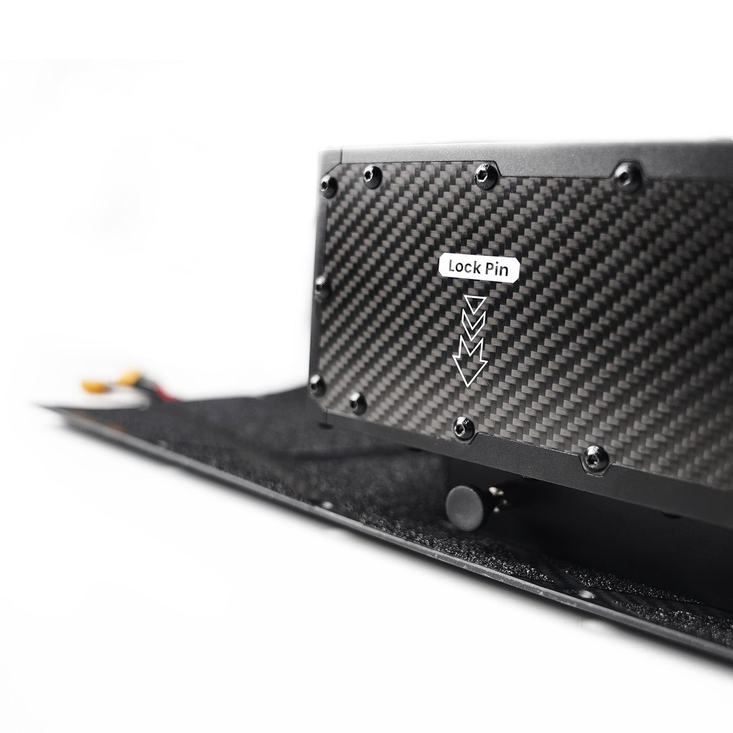 Close-up of Meepo Surge battery pack with lock pin on Hurricane skateboard deck
