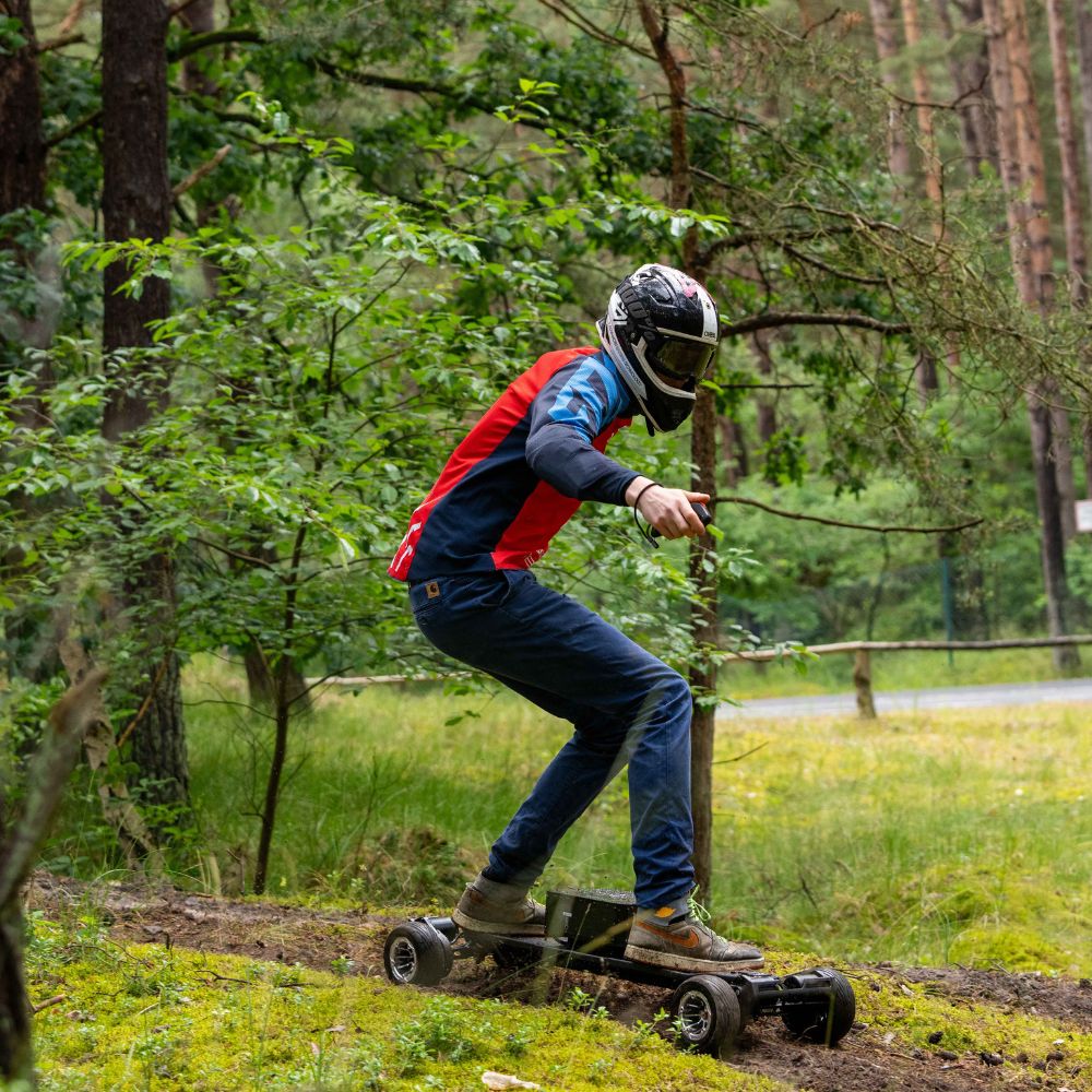 Rider maneuvering Meepo skateboard on a forest trail