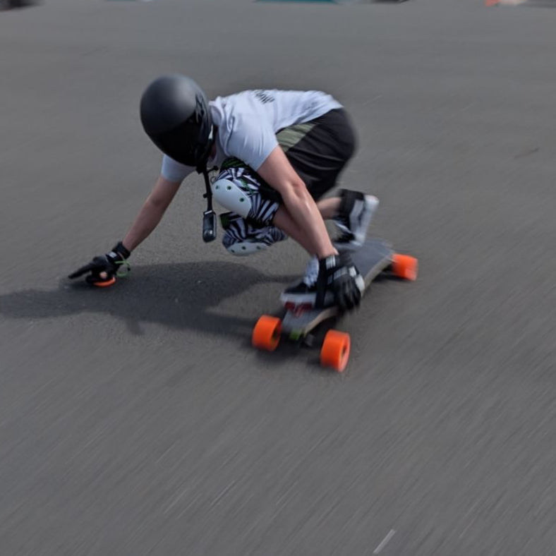 Skater performing a maneuver on a Meepo electric skateboard in a skate park.
