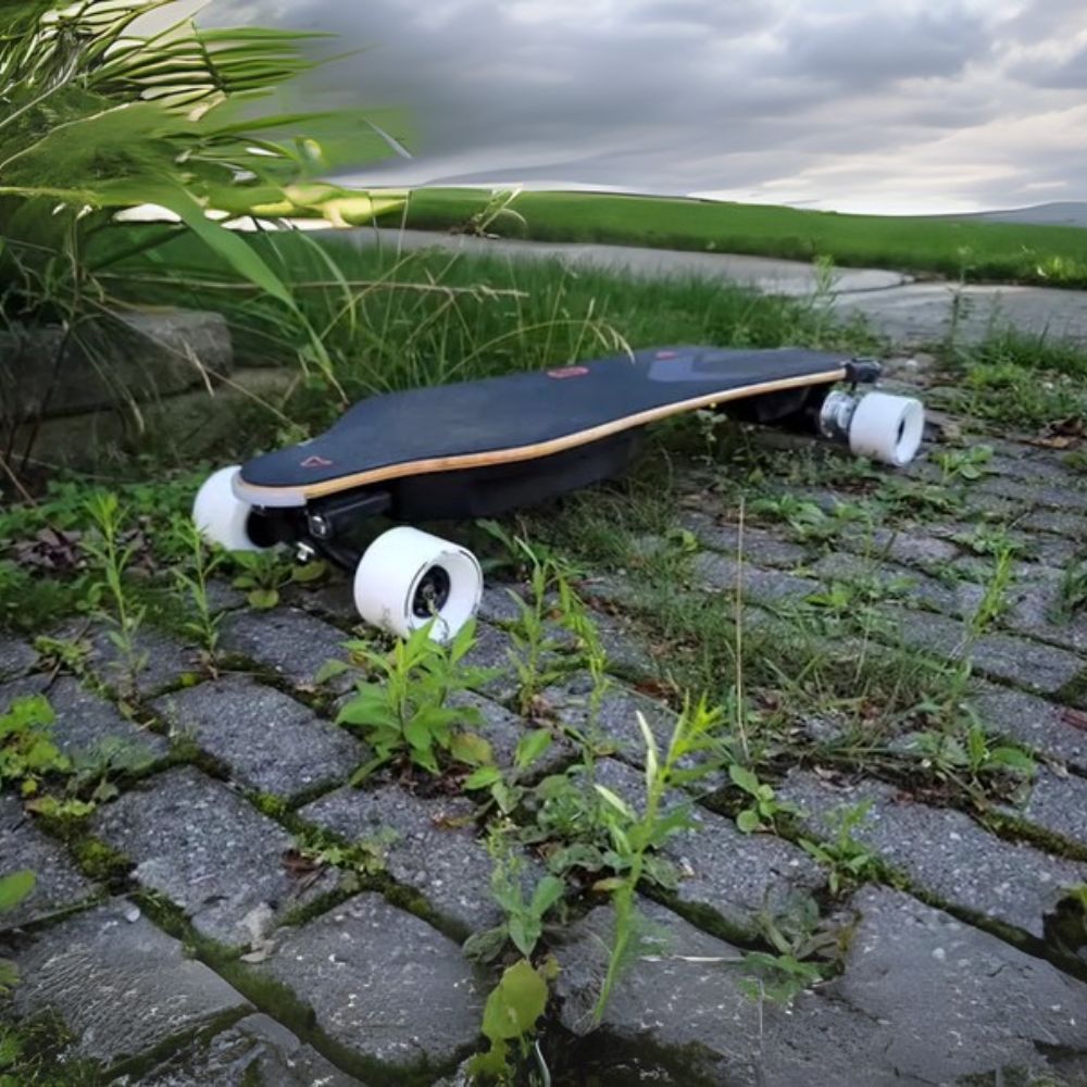 Meepo Voyager X skateboard on cobblestone path surrounded by greenery.