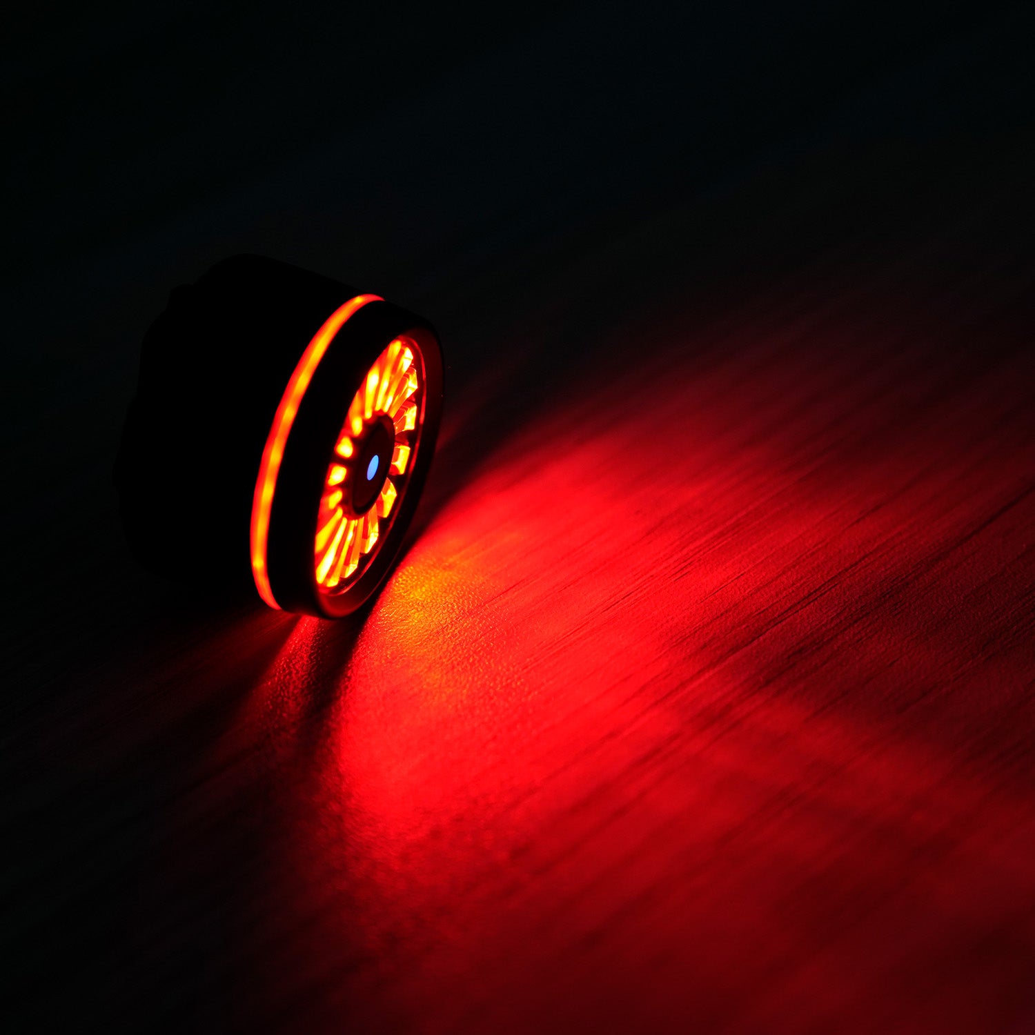 Red LED tail light emitting bright light for enhanced visibility on skateboards.