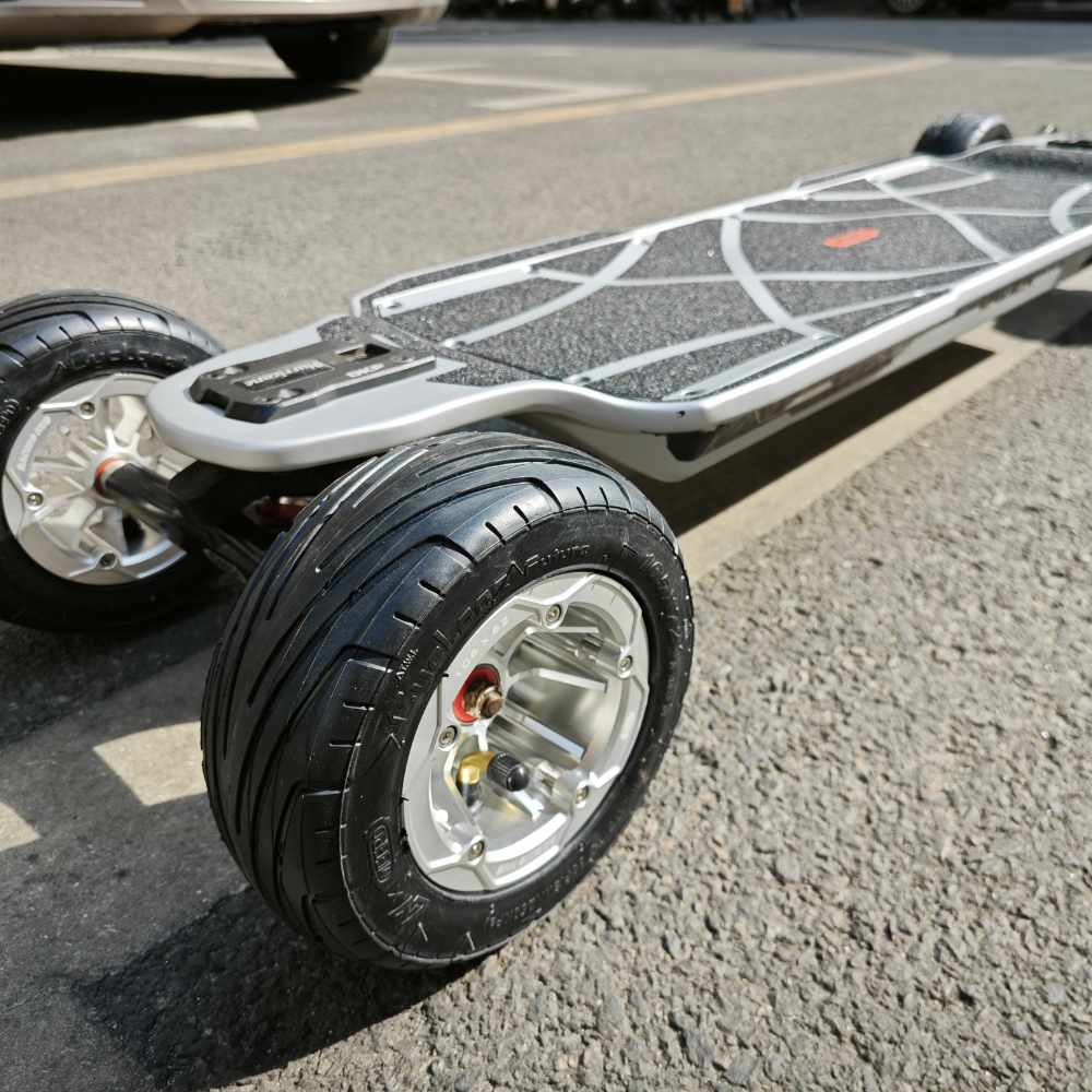 Close-up of Meepo Vader electric skateboard showcasing large racing wheels and textured deck.