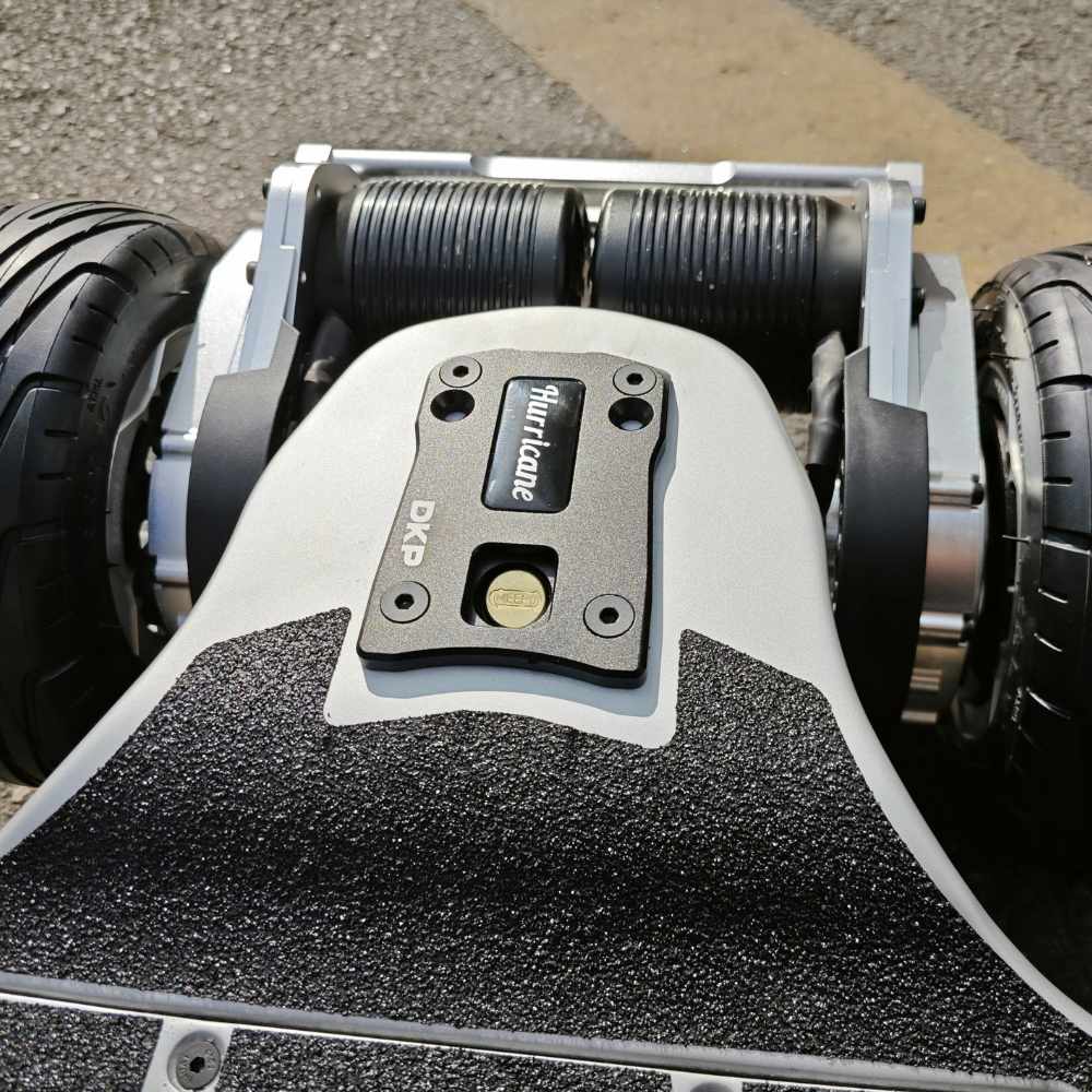 Close-up of Meepo Vader skateboard's deck and dual motors on a sunny day