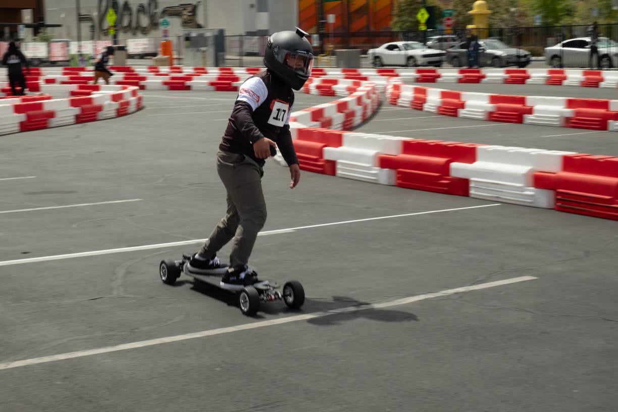 Rider demonstrating speed on Meepo Monsoon Legacy Raceboard in urban race track.