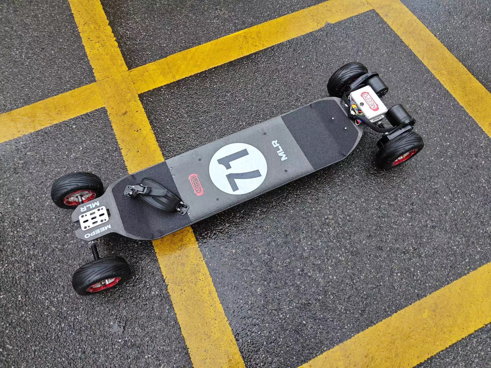 Meepo Monsoon Legacy Raceboard showcased on wet pavement, highlighting design and wheels.