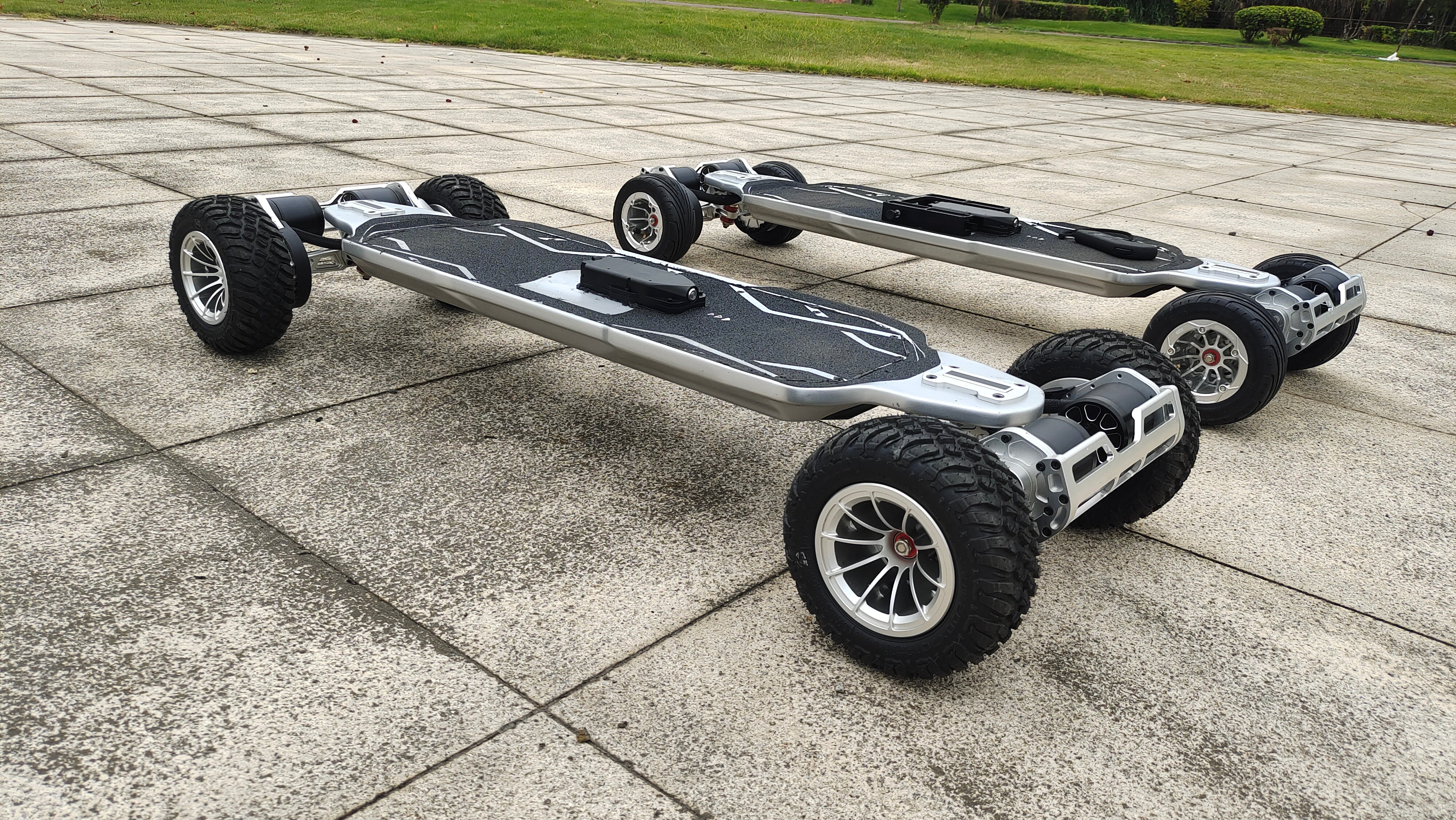Two Meepo electric skateboards with 200mm off-road tires for adventurous rides.