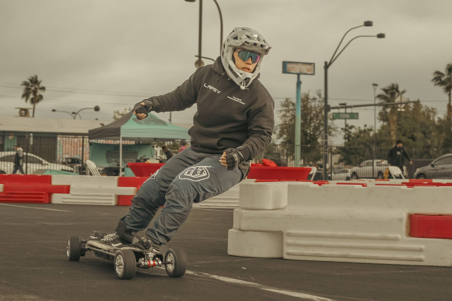 Rider skillfully maneuvering on Meepo Monsoon Legacy Raceboard around track barriers.