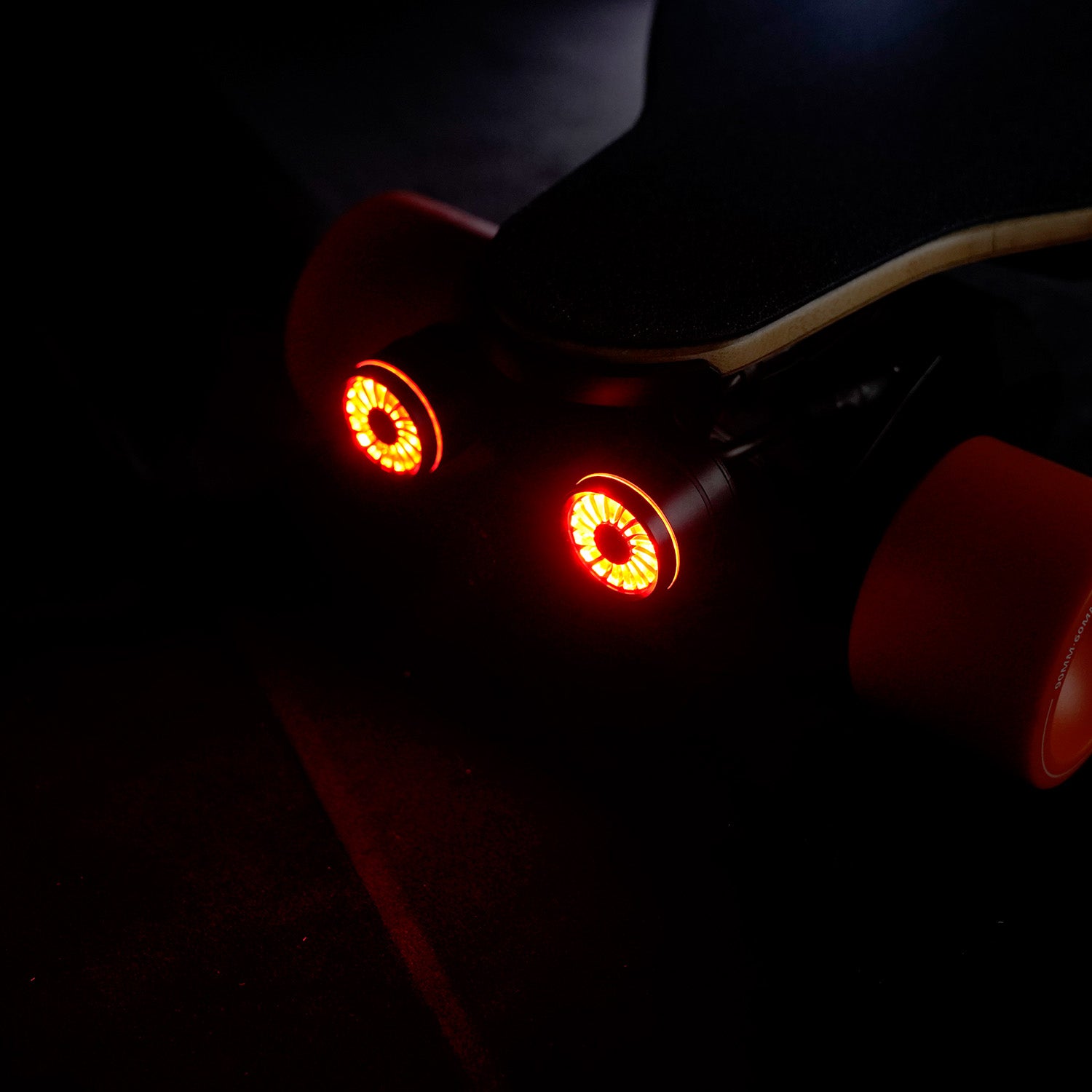 Meepo electric skateboard rear view with bright red LED tail lights.