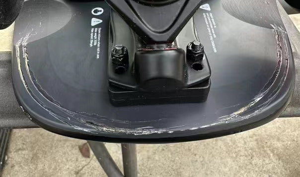 Close-up of Meepo refurbished skateboard deck with visible scratches and wear marks.