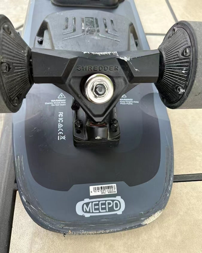 Close-up of Meepo skateboard truck and wheels showcasing durable construction.