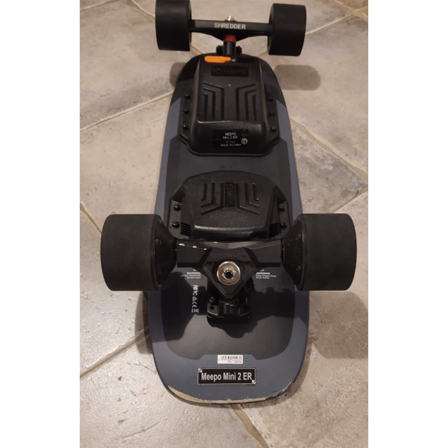 Meepo Mini 2 ER refurbished skateboard with textured black deck and large wheels.